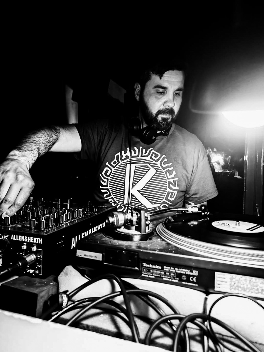 Manoli Moriaty DJing with vinyl records and a mixer