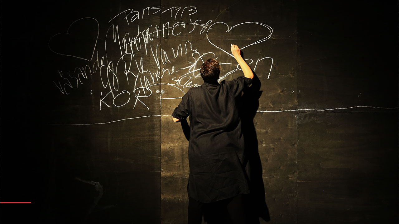 Dancer writing on a blacboard